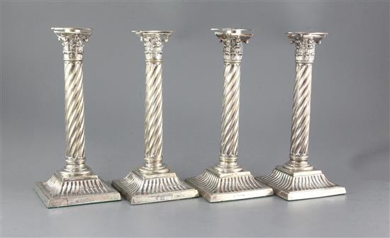 A set of four Victorian silver wrythen pillar candlesticks, 26.4cm.